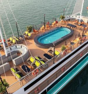a cruise ship with a swimming pool on the water