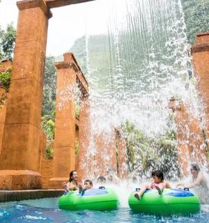 a group of children riding on tubes in a fountain