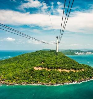 an island in the ocean with power lines on it