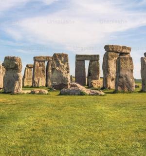 an ancient stone monument in a grassy field