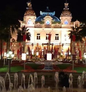 a building with a fountain in front of it at night