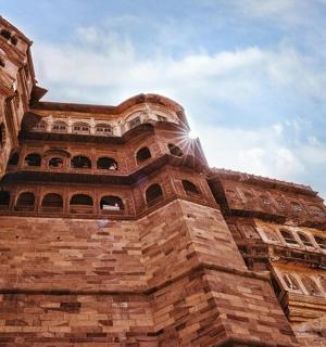 a tall brick building with a sky background