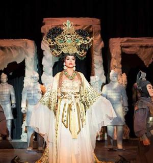 a woman in a costume on a stage