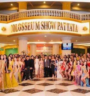 a large group of people posing for a picture in a lobby