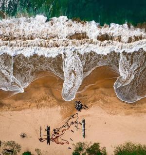 an aerial view of a beach with the ocean