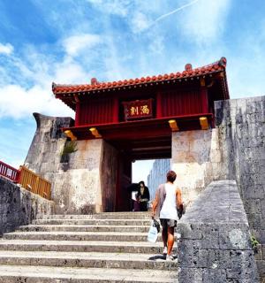 a man walking up some stairs in front of a building
