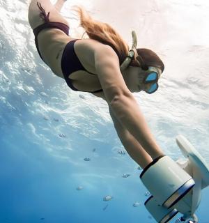 a woman floating in the water on a motor yacht