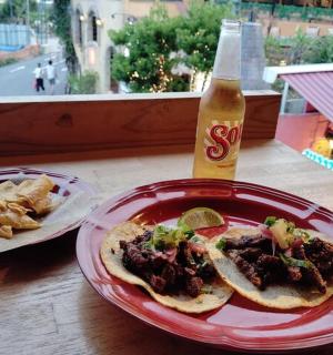 a plate of food on a table with a bottle of soda