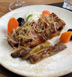 a plate of food with meat and vegetables on a table
