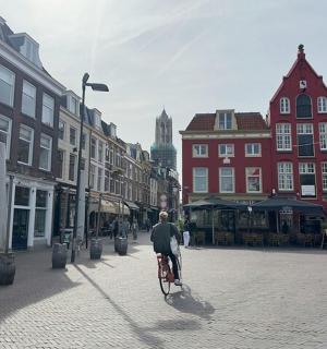 a man riding a bike down a street