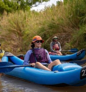 a group of people in kayaks on a river