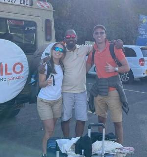 a group of three people standing in a parking lot