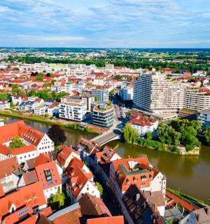 an aerial view of a city with a river and buildings