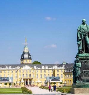 a statue in front of a large building