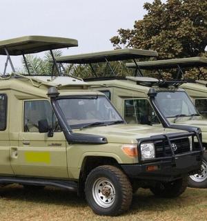 two green jeepneys parked next to each other