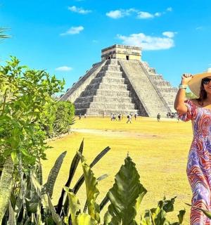 a woman standing in front of the pyramid