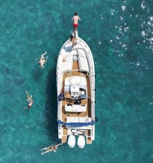 a boat with a man on top of it in the water