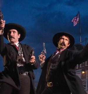 two men dressed up in costumes holding torches