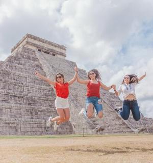 三个女孩在金字塔前跳跃