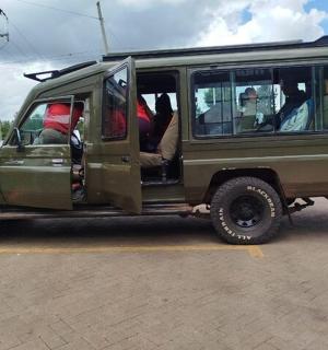 a green jeep parked in a parking lot