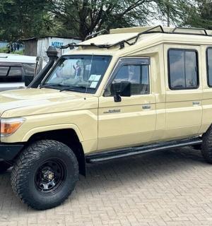a yellow jeep parked in a parking lot