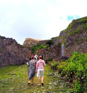 a group of people walking down a stone path