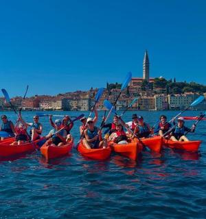 eine Gruppe von Menschen in Kajaks im Wasser