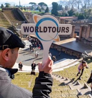 a man holding up a sign with the word wonders