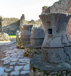 a group of stone statues sitting next to a building