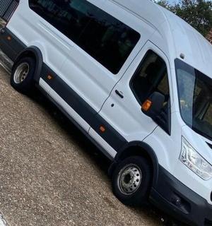 a white van parked next to a brick building