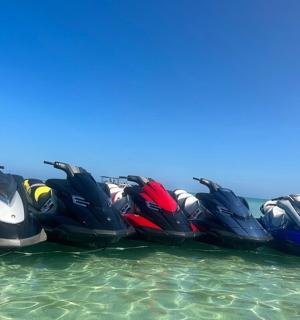 a group of four jet skis in the water
