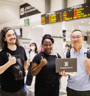 a group of three people standing in a airport