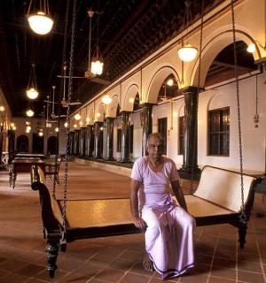 a woman sitting on a bench in a building