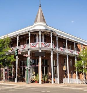 a building with a steeple on the corner of a street