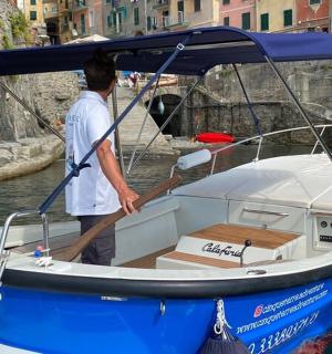 a man is standing on a blue and white boat