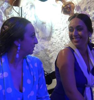 two women standing next to each other in a cave