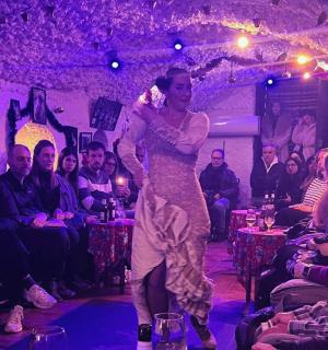 a woman in a dress walking on a dance floor