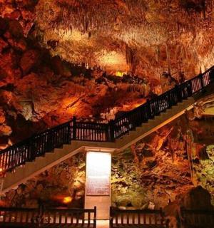 a staircase in a cave with a rock wall