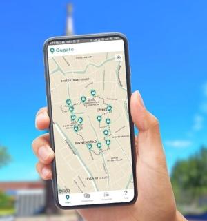 a person holding up a cell phone with a map