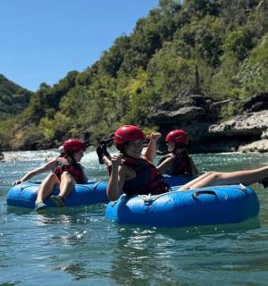 a group of people riding on rafts on a river