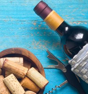 a bottle of wine and a bowl of wine corks