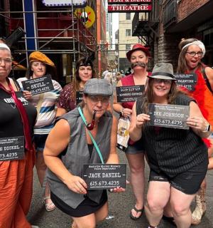 a group of people standing in a street holding signs