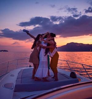 a group of people standing on the front of a boat