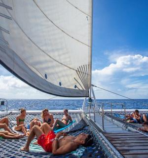 a group of people laying on the deck of a boat