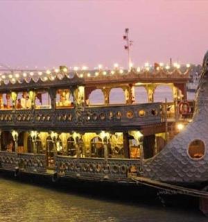a large boat in the water with lights on it