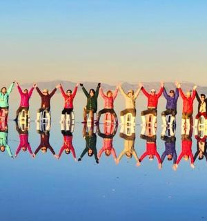a group of people holding their hands in the air