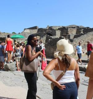 a group of people standing around at the ruins