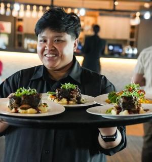 a man is holding a plate of food