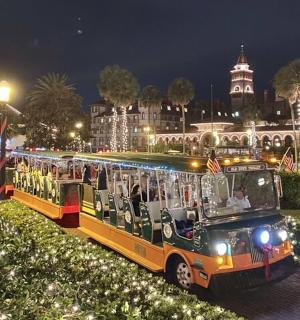 a bus filled with people is parked in front of a building
