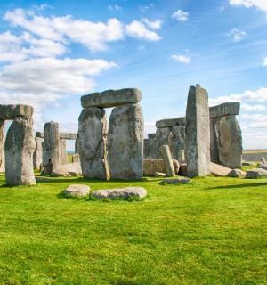 an ancient stonehenge monument with rocks in a field